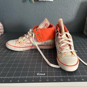 Orange and white graffiti Coach Converse sneakers